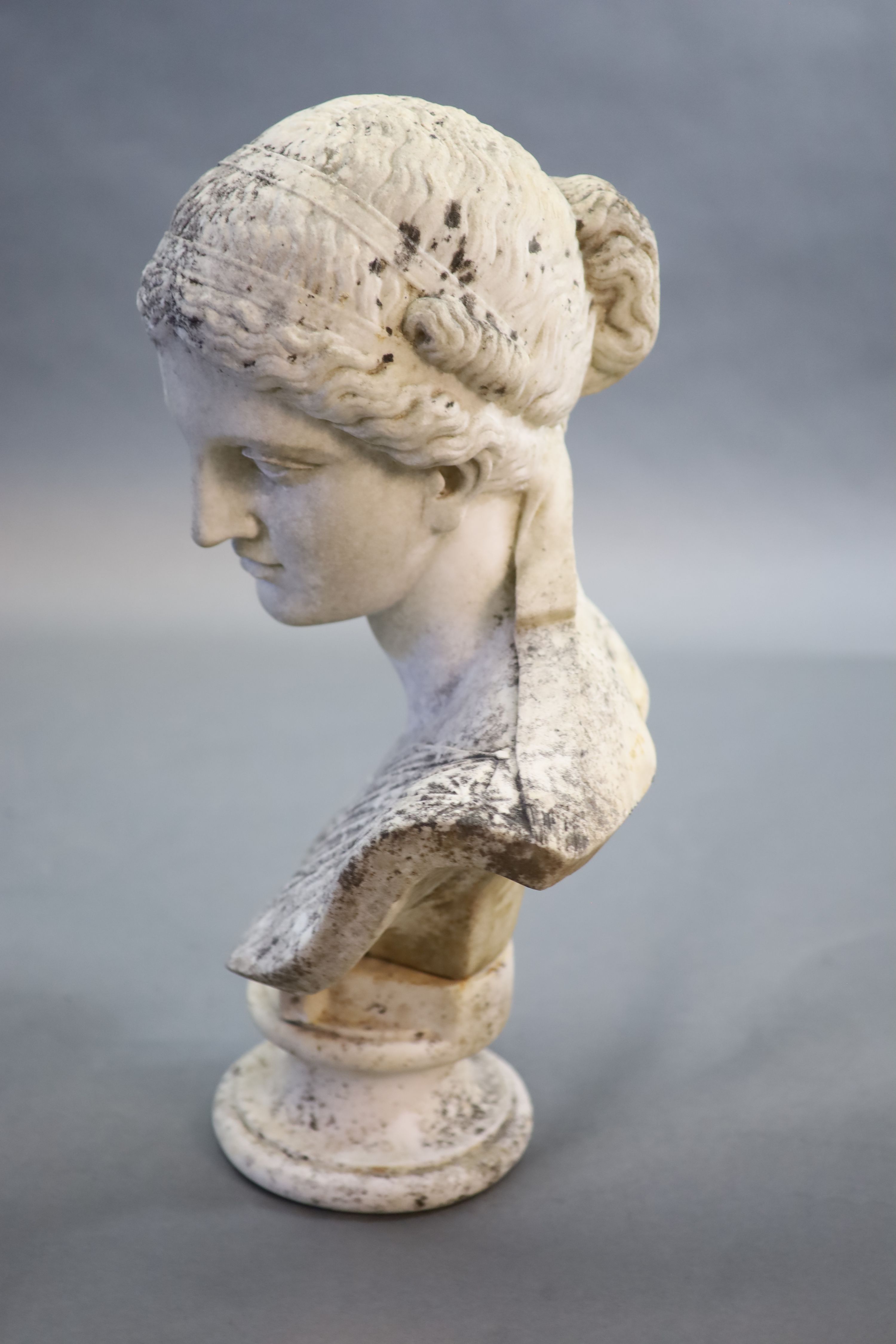 A large weathered white marble bust of a Grecian maiden, 19th century 52cm high (68cm combined, maximum)
